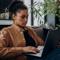 副業から起業へ移行する女性が自宅でパソコンを使って仕事をしているイメージ