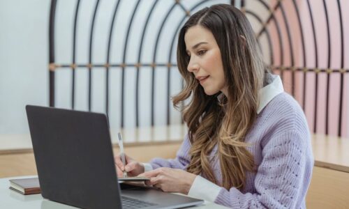 起業マインドセットを持つ女性経営者がノートに思考を書き出している様子