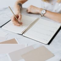 パーソナルブランド作り方を学ぶ女性経営者がノートに自分の強みと価値観を書き出している様子